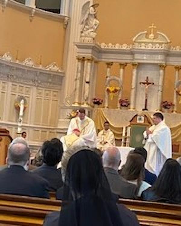 Newly ordained Priest Gregory Caldwell looks on as newly ordained Priest Fr. Brandon Schneider blesses the Most Reverend Bishop Christopher Coyne at the conclusion of the Ordination Mass.  